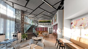 A modern restaurant with a staircase, dining tables, and chairs. - Stylish Studio + Den Across from Bayside Miami! (Miami)