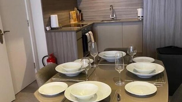 A dining table set for six with white plates, glasses, and cutlery. - Cocoa Suites-2 Bed-city Centre-pets-parking (York)