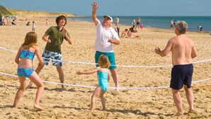 A beach volleyball game with players and spectators. - Aughrim Holiday Village No 14 (Aughrim)
