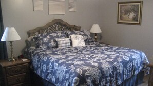 A bedroom with a large bed, two bedside tables, and a nightstand.