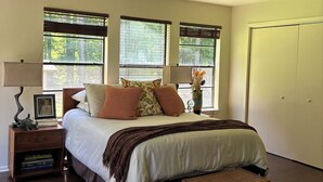 A bedroom with a bed, nightstands, a ceiling fan, and a window with blinds. - Perfect Poolhouse (Linden)