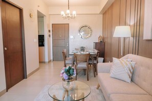 Relax in this stylish living room with a sofa, coffee table, and dining area.