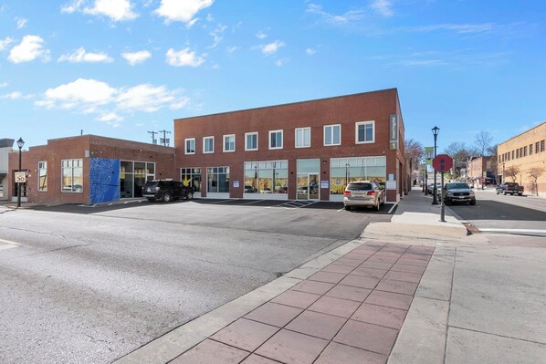 A two-story building with a brick facade, large windows, and a blue tarp covering part of the lower level. - Downtown Cape 2 Bdrm/2 Bath Apt, Cozy & Walkable (Cape Girardeau)