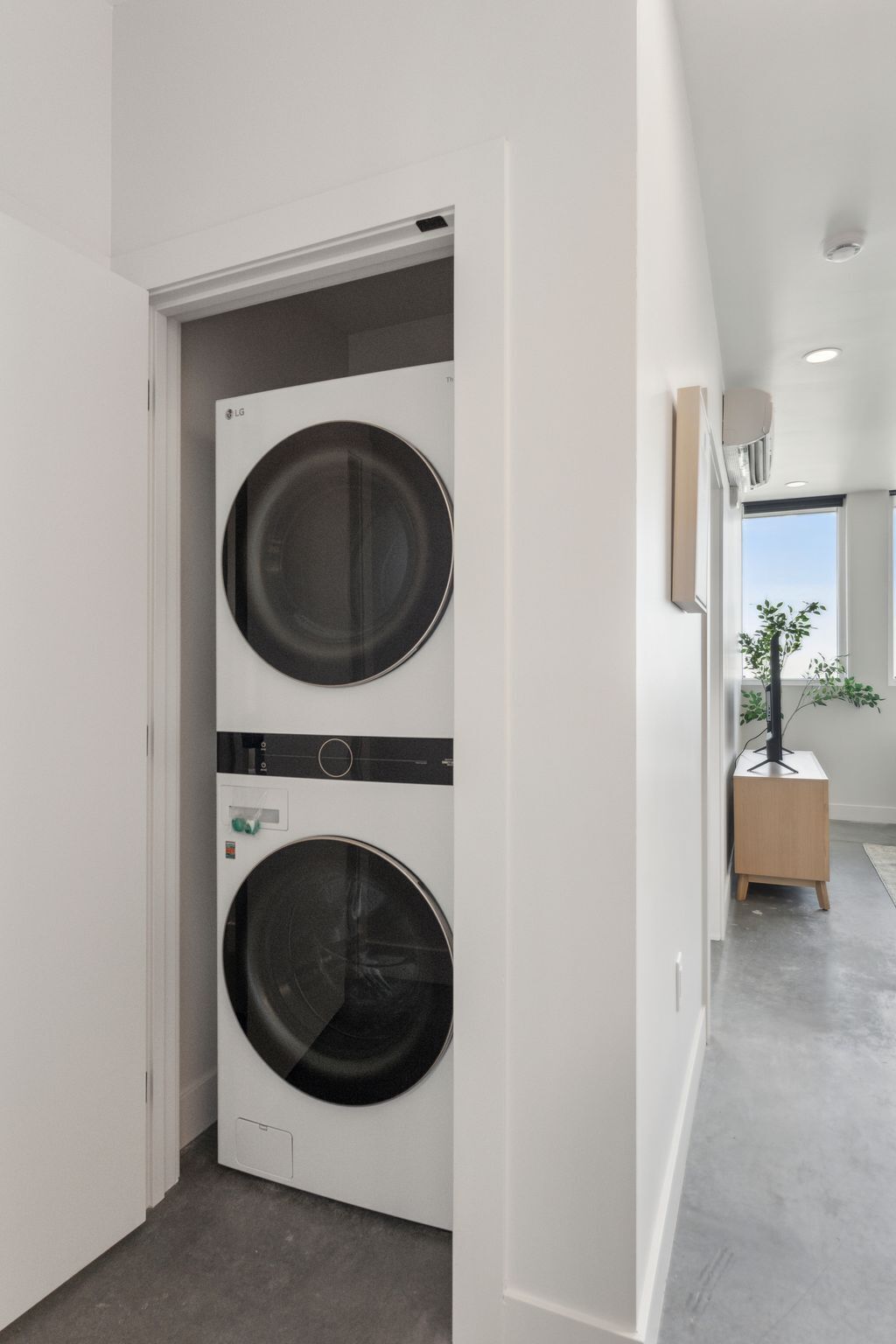 A laundry room with two stacked front-loading washing machines.