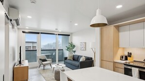 A modern apartment with a kitchen, dining area, and living space. -  Placemakr Salt Lake City Downtown, Apartments by Hilton (Salt Lake City)