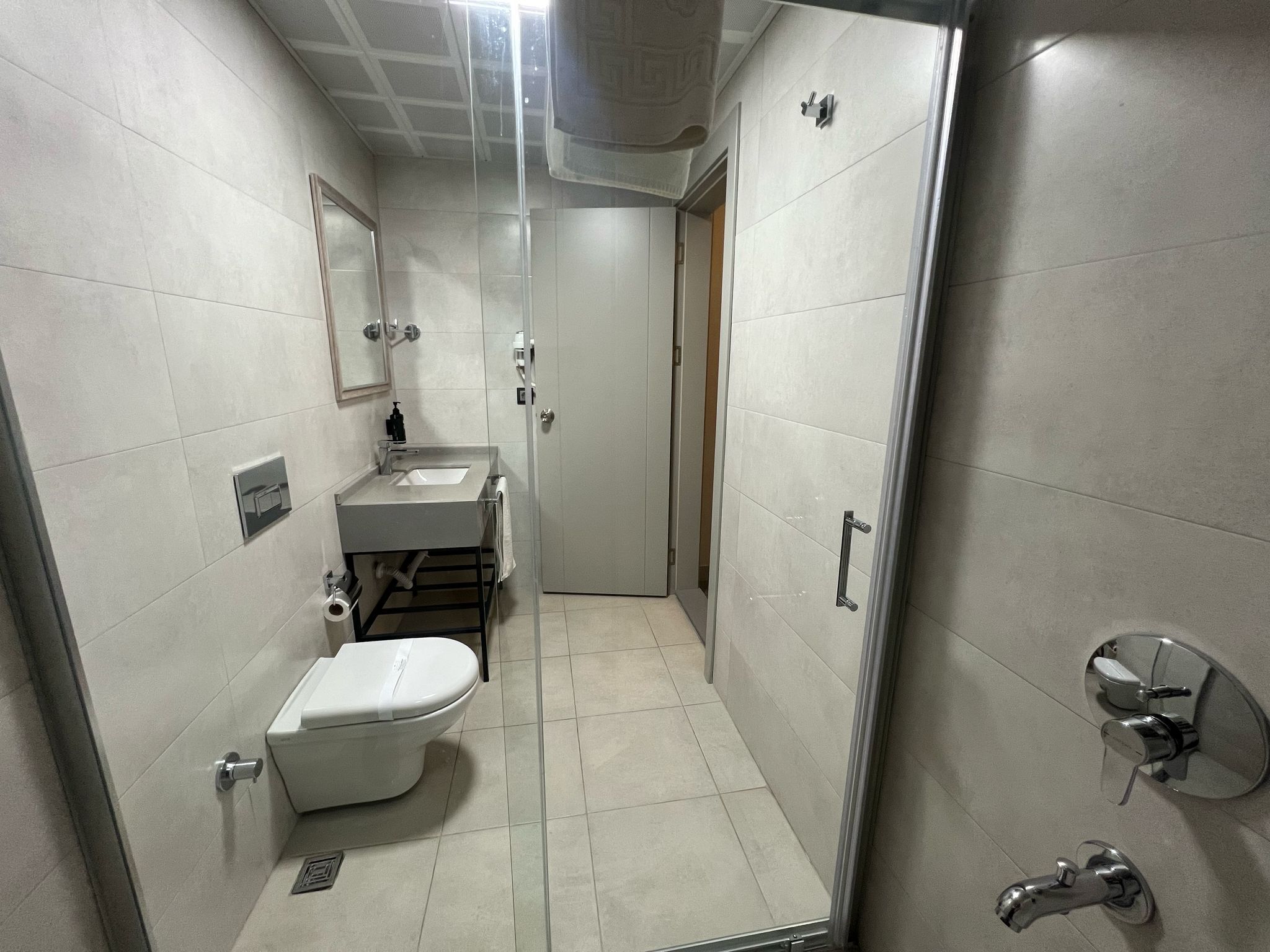 Shower, hair dryer, slippers, towels