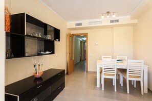 Enjoy a clean and minimalist space with a console table, dining table, and shelving unit.