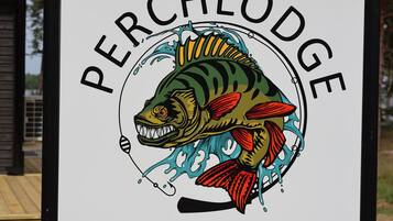 A sign with a fish illustration and the text "PERCHLODGE" and a website address.
