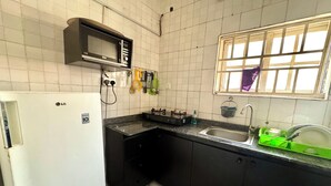 A kitchen with a white LG refrigerator, a microwave, a gas stove, and a sink.