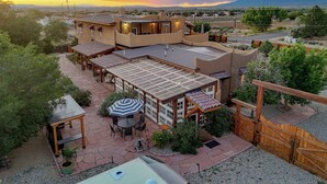 A resort with outdoor patios, a pool, and a view of the mountains.