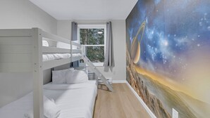 A room with a bunk bed, a window with curtains, and a wall mural of a space scene. - Hot Tub*Arcade*Pool Table*King Bed*75" TV*Fire Pit (Pocono Summit)