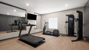A modern gym with a treadmill, elliptical, and weight machine. - Echo Suites Extended Stay By Wyndham Johnson City Medical Cr (Johnson City)
