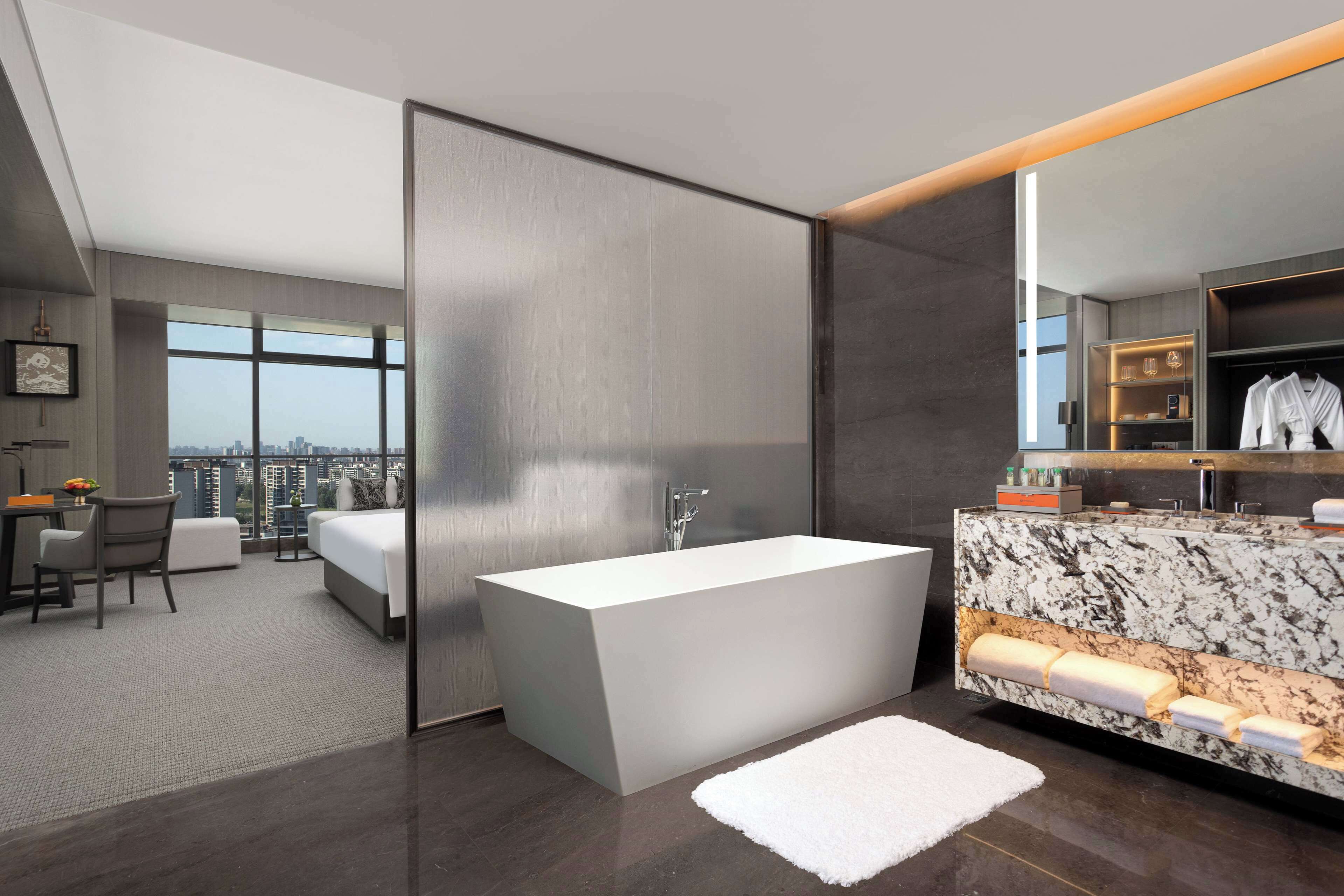 Grand Room, 1 King Bed, City View | Bathroom | Separate tub and shower, rainfall showerhead, designer toiletries