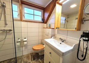 A bathroom with a toilet, sink, and shower. - Apartment in Gnesau With Swedish Hot Tub (Gnesau)