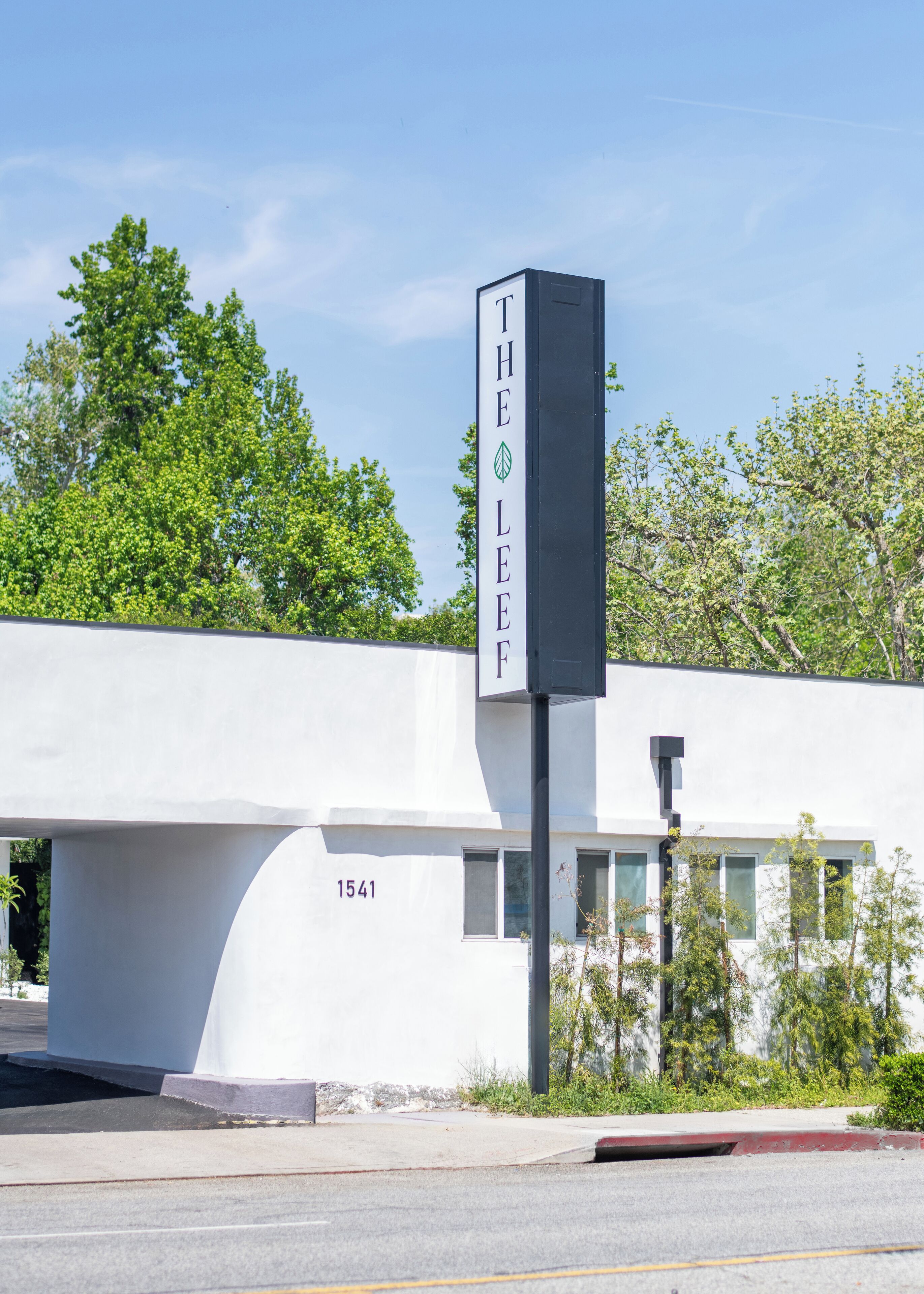 A modern building with a vertical sign reading "THE LEAF".