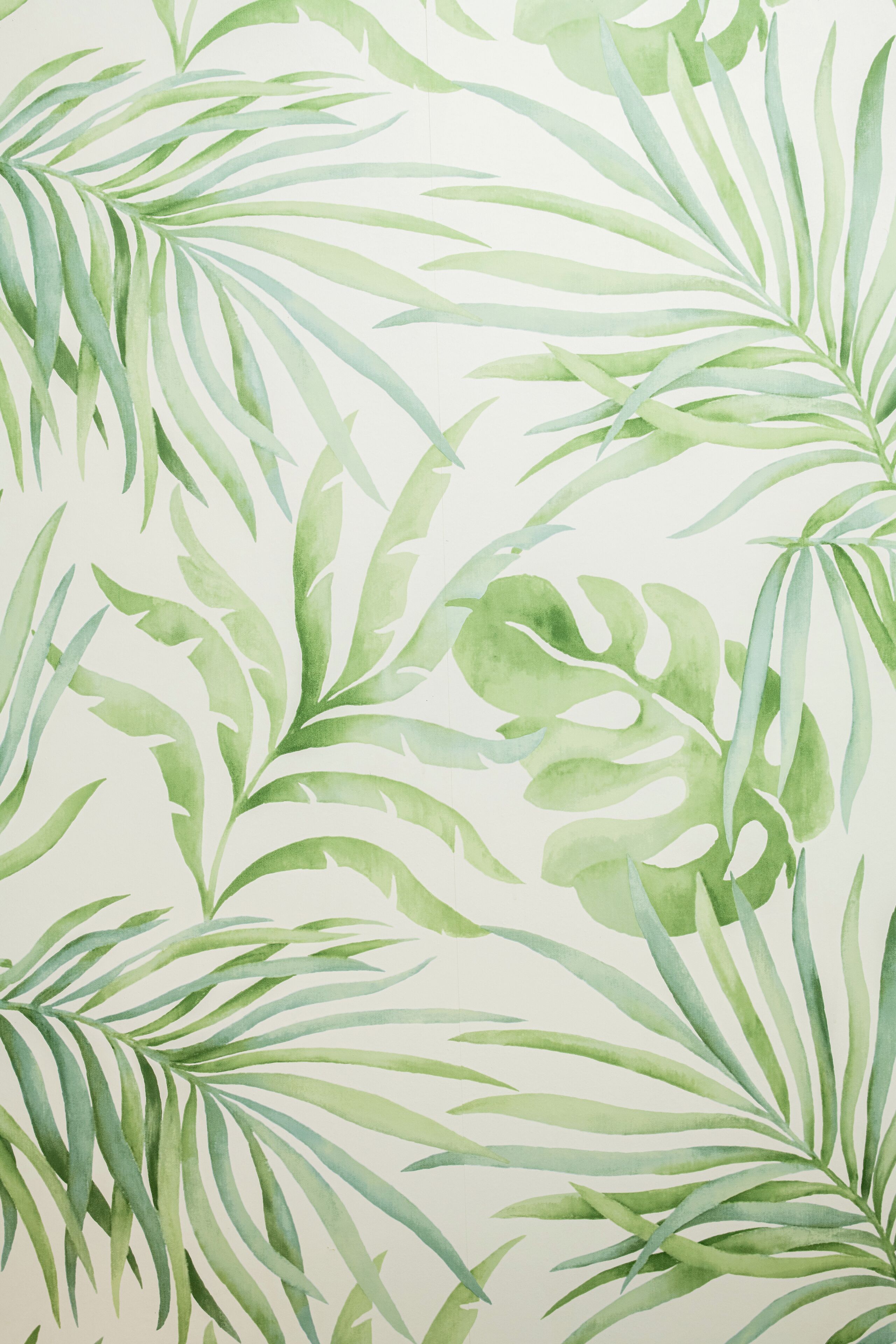 A pattern of green leaves on a plain background.