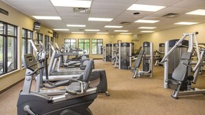 A gym with treadmills, elliptical machines, and weight machines.