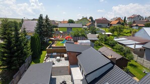 A residential area with houses, a playground, and a clear sky. - Apartmány Žakovce & SPA (Vysoké Tatry)