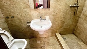 A bathroom with a sink, toilet, and shower.