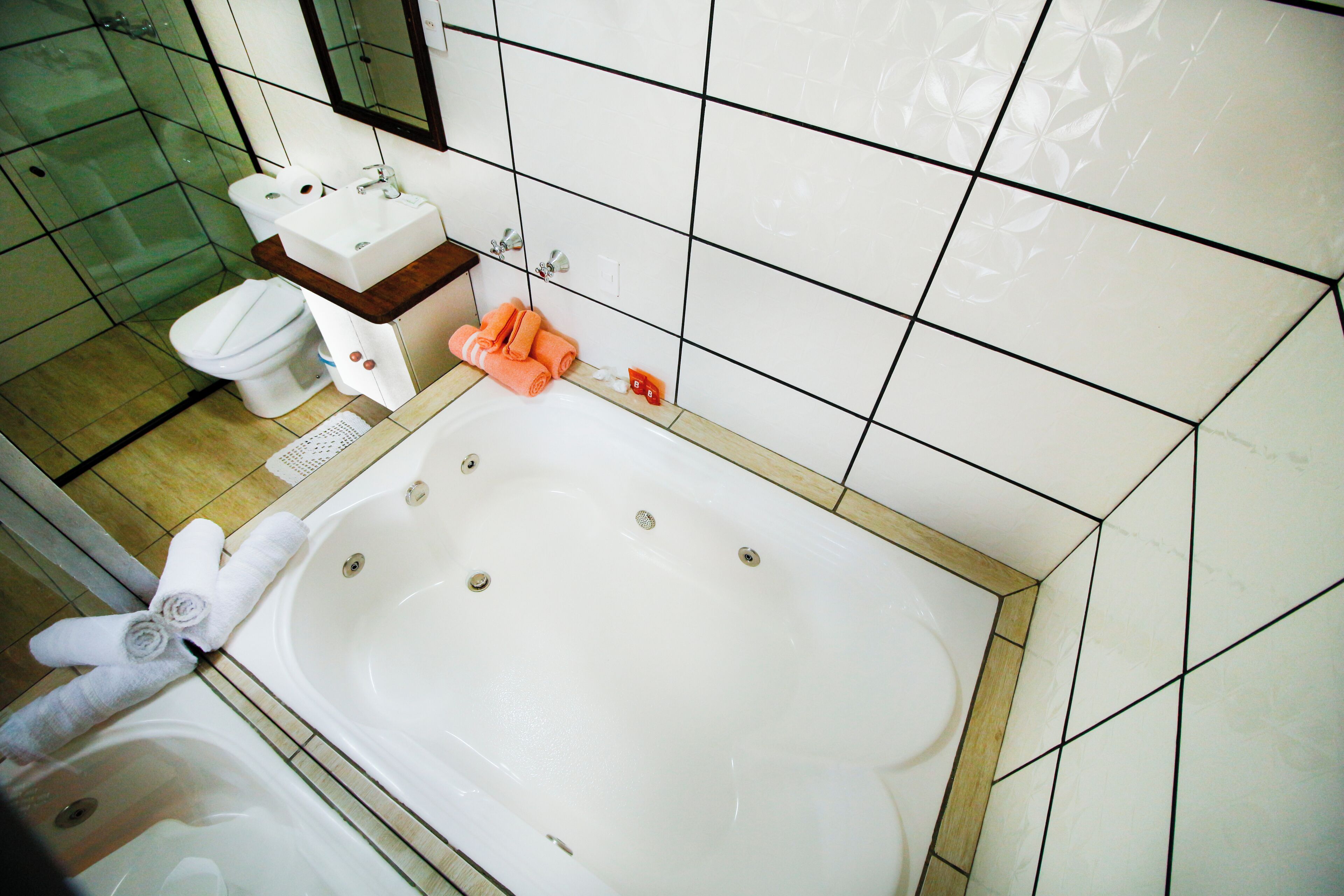 A bathroom with a bathtub, toilet, and sink.