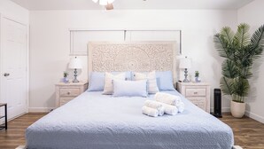 A bedroom with a bed, nightstands, a ceiling fan, and a potted plant. - Cozy & Stylish Apartment for 4 just 5 Minutes from Downtown (Mount Dora)