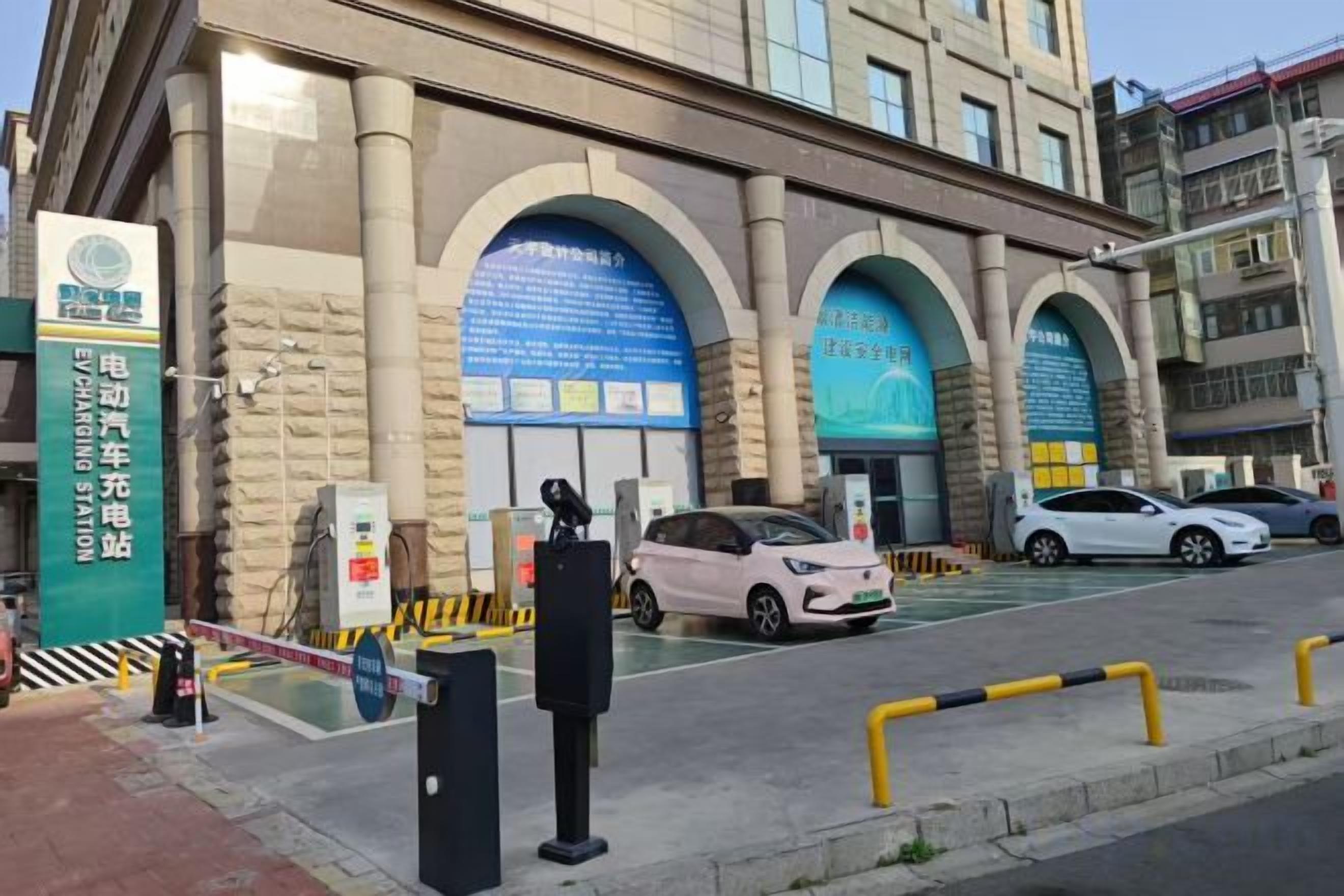 A building with multiple arches and a parking area with cars.