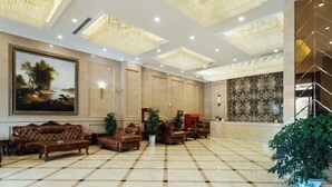 A spacious lobby with a checkered floor, leather sofas, a large painting, and a decorative ceiling. - Lavande Hotel (Suining Heping West Road) (Suining)