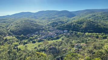 A mountainous landscape with a small village nestled among the hills.