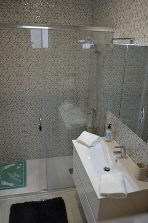 Shower, hair dryer, towels, soap