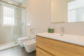 Een douche, een haardroger, een bidet, handdoeken