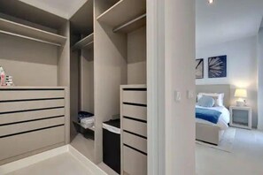 A bedroom with a bed, bedside tables, and a nightstand.