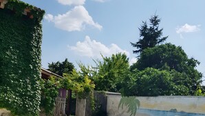 A rectangular swimming pool with a clear blue water surface, surrounded by a tiled deck. - Holiday Home 'La Alameda' with Private Pool, Garden, BBQ & Wi-Fi (MARAZUELA)