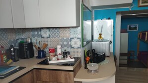 A kitchen with a countertop, a coffee maker, a kettle, and a refrigerator. - Apartment 'I Due Soli' with Sea View, Wi-Fi and Air Conditioning (Santa Cesarea Terme)