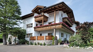 A two-story building with wooden balconies, stone walls, and potted plants. - Holiday Apartment 'Klementhof No. 2' with Mountain View, Shared Pool and Wi-Fi (Naz-Sciaves)