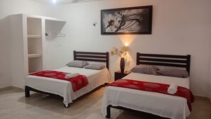 Una habitación con dos camas, un armario, un ventilador de techo y un cuadro en la pared.