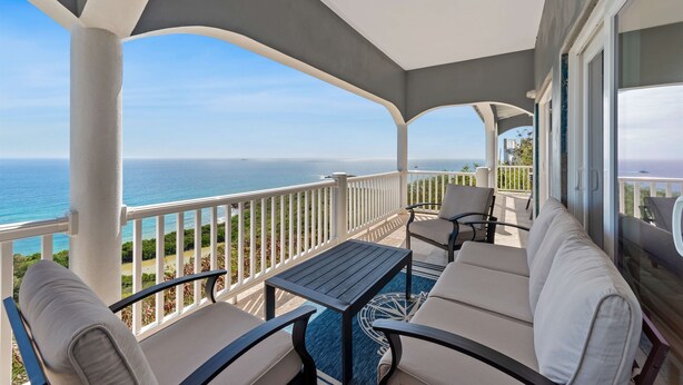 A balcony with a view of the ocean, a table, and two sofas. - Sleeps 9 - Generator - Central Location - POOL! (St. Thomas)