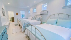 A bedroom with two beds, a dresser, and a window. - 2 Adjacent Houses Rented Together!! (Swanton)