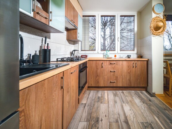 Enjoy cooking in this well-equipped kitchen with an oven and stainless steel sink.