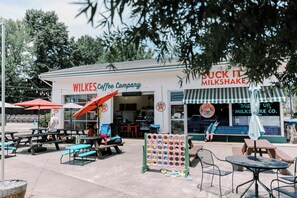 A coffee shop with outdoor seating, a milkshake sign, and a Texaco gas station sign. - Cozy 2BR with AMAZING views in Buck Mountain (Purlear)