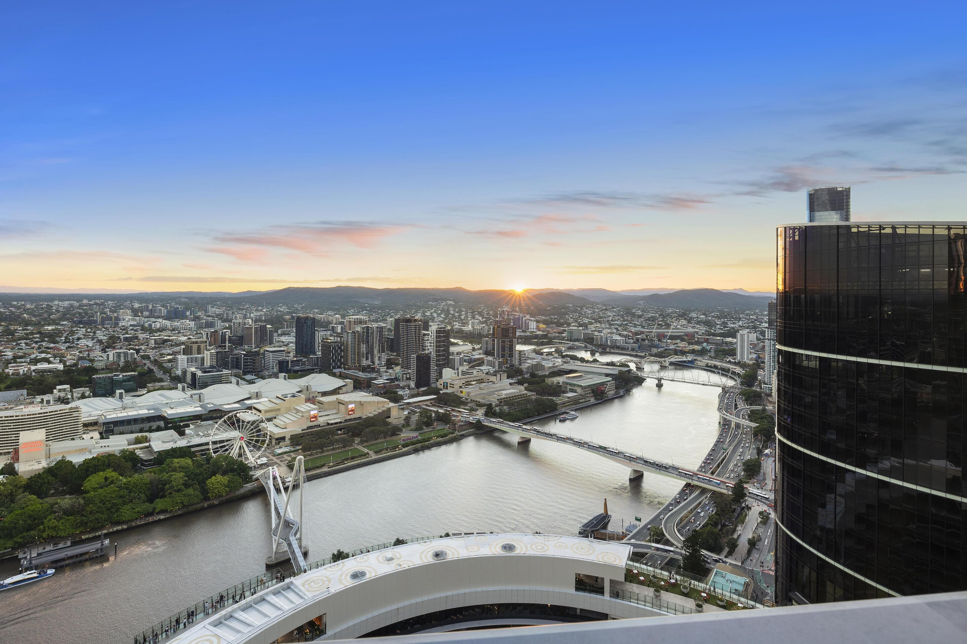 A cityscape with a river, bridges, and modern buildings.