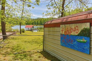 A fenced area with a gazebo, a lake, and a painted wall with 'Ladybug Lake' text. - NEW LISTING !!! RUSTIC MEADOW AT LADYBUG LAKE (Morganton)