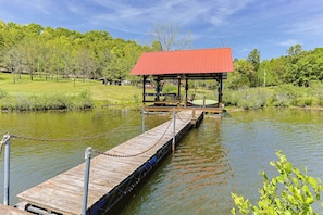 A wooden dock leading to a covered pavilion with seating, surrounded by a calm lake and lush greenery. - NEW LISTING !!! RUSTIC MEADOW AT LADYBUG LAKE (Morganton)
