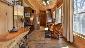 A wooden interior with a staircase, a wooden dining table, and a chandelier. - NEW LISTING !!!  RUSTIC MEADOW AT LADYBUG LAKE (Morganton)