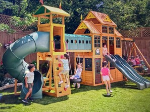 A children's play structure with multiple slides and climbing areas.