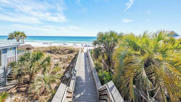 A wooden boardwalk leading to a beach with palm trees and a clear blue sky. - Grayt Days by Stay on 30a (Santa Rosa Beach)
