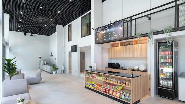 A modern lobby with seating, a snack bar, and a vending machine. - Infinite Hotel Kaset-Senanikom (Bangkok)