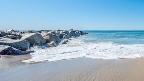 A beach with large rocks and waves.
