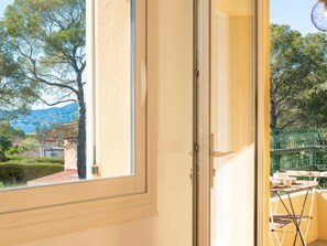 Enjoy a peaceful retreat with a balcony offering a scenic view of the surrounding landscape and a space for outdoor dining or relaxation.