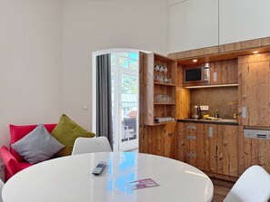 Una cocina moderna con armarios de madera, microondas y cafetera.