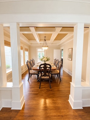 A dining room with a long table, chairs, and a chandelier. - Anne Haven Spacious Retreat DT Seattle (Seattle)